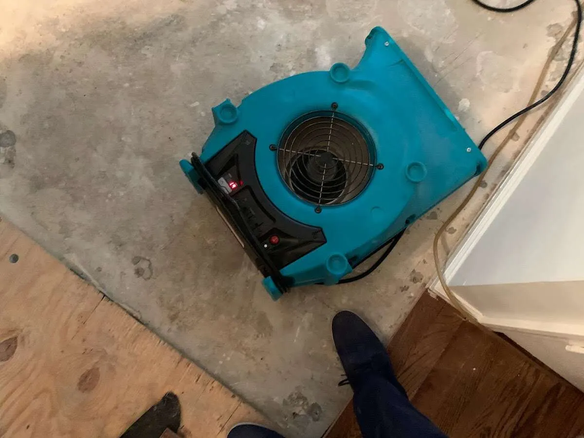 Air mover drying subfloor during Commercial Water Damage Restoration in Briar Chapel
